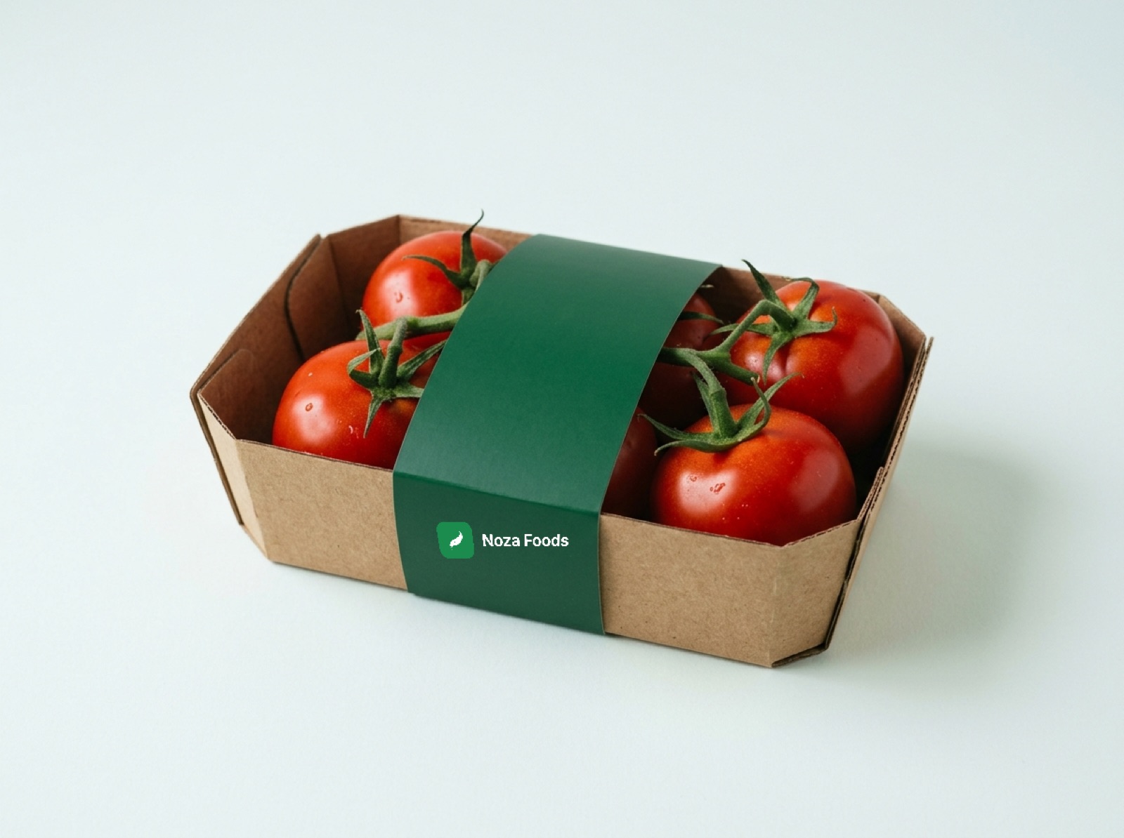A kraft cardboard punnet of vine tomatoes wrapped with a green Noza Foods band